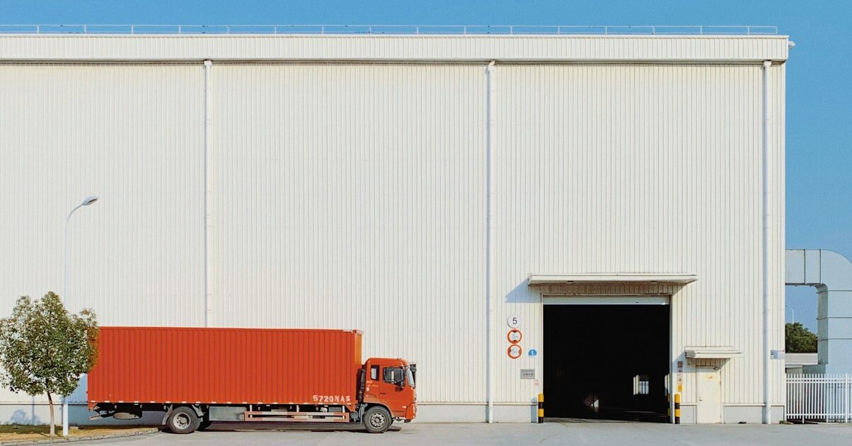 red freight truck beside building